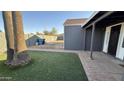 Spacious backyard with artificial grass and potential for landscaping at 4231 E Carter Dr, Phoenix, AZ 85042