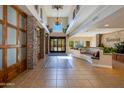 Grand lobby entrance with stone pillars, high ceilings, chandelier, tiled flooring, and comfortable seating at 5350 E Deer Valley Dr # 4408, Phoenix, AZ 85054