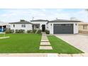 Charming home with a green lawn and a brick walkway leading to the front door with garage at right at 6719 N 10Th Pl, Phoenix, AZ 85014