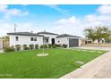 Attractive single-story home boasts a well-manicured lawn, modern design, and inviting curb appeal at 6719 N 10Th Pl, Phoenix, AZ 85014