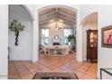 Spacious foyer with vaulted ceilings, tile flooring and views into the living room at 8270 E Corrine Dr, Scottsdale, AZ 85260