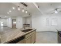 Contemporary kitchen island with granite countertops, pendant lighting, and an open layout perfect for entertaining at 8653 E Royal Palm Rd # 1006, Scottsdale, AZ 85258