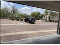View from garage of brick-paved parking area with assigned parking spot and desert landscaping at 10219 E Isleta Ave, Mesa, AZ 85209