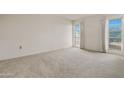 Bright, carpeted bedroom featuring two windows with blinds and neutral paint at 10509 W Oak Ridge Dr, Sun City, AZ 85351