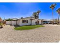 Rear view of a single-story stucco home featuring low-maintenance landscaping, and a detached garage at 113 W Rawhide Ave, Gilbert, AZ 85233