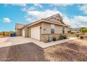 Spacious three-car garage with concrete driveway and well-maintained landscaping around the home's exterior at 13729 E Rancho Laredo Dr, Scottsdale, AZ 85262