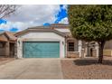 Attractive single-story home boasts a blue garage door, stone accents, and manicured front yard at 1434 W Brangus Way, San Tan Valley, AZ 85143