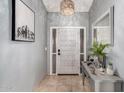 Welcoming foyer featuring neutral tones, tiled floor, and a decorative lighting fixture at 14402 N Silverado Dr, Fountain Hills, AZ 85268