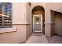 Close up of front door in neutral tones, with a decorative wreath and a welcoming entrance at 15050 N Thompson Peak Pkwy # 1006, Scottsdale, AZ 85260