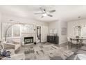 Bright living room with a fireplace, ceiling fan, and neutral decor for a cozy and stylish atmosphere at 15050 N Thompson Peak Pkwy # 1006, Scottsdale, AZ 85260