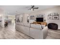 Bright and airy living room featuring wood floors, comfortable seating, and a modern ceiling fan at 1841 E Clarendon Ave, Phoenix, AZ 85016