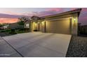 Well-maintained home featuring a three-car garage and concrete driveway at 18938 W Luke Ave, Litchfield Park, AZ 85340