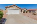 Charming single-story home with a spacious driveway and low-maintenance desert landscaping in the front yard at 2142 E Wildhorse Dr, Chandler, AZ 85286