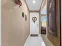 Inviting foyer featuring neutral walls, marble flooring, and a view into the living area at 21609 N Diamond Dr, Maricopa, AZ 85138