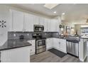 Modern kitchen with stainless steel appliances, updated countertops, and sleek white cabinetry at 2263 N Trekell Rd # 113, Casa Grande, AZ 85122