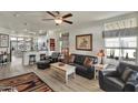 Inviting living room featuring a ceiling fan, wood floors, comfortable seating, and natural light at 2263 N Trekell Rd # 113, Casa Grande, AZ 85122