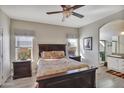 Warm bedroom features a ceiling fan, neutral colors, and an en-suite bathroom for added privacy at 2263 N Trekell Rd # 113, Casa Grande, AZ 85122