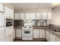 A bright kitchen with white cabinetry, countertops, and appliances at 2528 E Mckellips Rd # 74, Mesa, AZ 85213