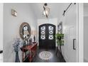 Stunning foyer with dark wood floors and black double doors at 2608 Leisure World --, Mesa, AZ 85206