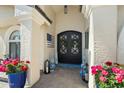 Inviting front entrance featuring double doors, decorative wreath, and colorful potted plants at 2608 Leisure World --, Mesa, AZ 85206