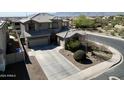 Aerial view of a two-story home with a long driveway and meticulously maintained landscaping in a residential area at 2811 W Glenhaven Dr, Phoenix, AZ 85045