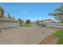 Large paved backyard featuring detached garage, backyard patio and secure fencing at 3333 N 81St Ave, Phoenix, AZ 85033