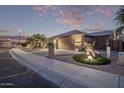 The exterior of this home features professional desert landscaping and multiple garage doors at 3544 N 149Th Ave, Goodyear, AZ 85395