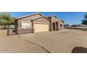 Cozy single-story home with a two-car garage and a paved driveway and walkway at 3720 E Vista Grande --, San Tan Valley, AZ 85140