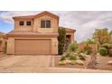 Inviting home exterior showcasing desert landscaping, a tile roof, and a two-car garage adding charm and practicality at 4365 E Milton Dr, Cave Creek, AZ 85331