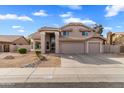 Charming tan two-story home featuring a well-maintained yard and attached two-car garage at 4607 E Rancho Laredo Dr, Cave Creek, AZ 85331