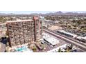 A high-rise building positioned near a city street, adjacent to a parking lot, offering urban living at 4750 N Central Ave # 12H, Phoenix, AZ 85012