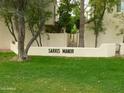 Well-manicured community signage and lush green lawn at 4818 N 73Rd St, Scottsdale, AZ 85251