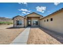 Charming single-story home featuring a neutral stucco exterior with stone accents, walkway, and mountain views at 6107 E Lone Mountain Rd, Cave Creek, AZ 85331