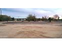 A modern single-story home with desert landscaping under a cloudy sky, featuring native trees and foliage at 6107 E Lone Mountain Rd, Cave Creek, AZ 85331