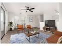 Cozy living room with modern furnishings, a ceiling fan, and plenty of natural light at 702 S Beck Ave, Tempe, AZ 85281