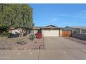 Inviting single-story home with a spacious driveway, mature trees, and a classic design at 7132 W Vermont Ave, Glendale, AZ 85303