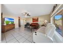 Comfortable living room with tile flooring, modern furniture, and ample natural light from the large windows at 7132 W Vermont Ave, Glendale, AZ 85303