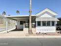 Charming single-story home with covered parking, a front patio, and desert landscaping at 864 S Motherlode Dr, Apache Junction, AZ 85119