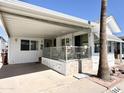 Inviting covered front porch with tile flooring, storage, and seating at 864 S Motherlode Dr, Apache Junction, AZ 85119