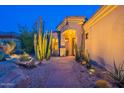 A well-lit entrance with desert landscaping highlights a charming facade with a stone walkway at 9431 N Summer Hill Blvd, Fountain Hills, AZ 85268