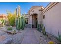 Inviting home entrance featuring desert landscaping, a stone walkway, and a neutral-toned facade at 9431 N Summer Hill Blvd, Fountain Hills, AZ 85268