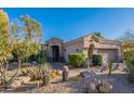 Desert-style home with well-maintained landscaping, including cacti and native plants in a rock garden at 9431 N Summer Hill Blvd, Fountain Hills, AZ 85268