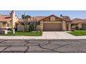 Inviting single-story home with a well-manicured lawn and two-car garage at 9803 N 100Th Pl, Scottsdale, AZ 85258