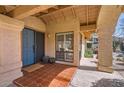 Welcoming front porch with a blue door and tiled flooring at 9803 N 100Th Pl, Scottsdale, AZ 85258