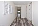 Bright hallway showcasing stylish wood-look floors and contemporary artwork at 10730 W Escuda Dr, Peoria, AZ 85373