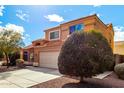 Charming two-story home featuring a well-maintained yard, a spacious driveway, and a classic two-car garage at 12462 N 75Th Ln, Peoria, AZ 85381