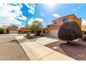 Charming two-story home featuring a well-maintained yard, a spacious driveway, and a classic two-car garage at 12462 N 75Th Ln, Peoria, AZ 85381