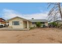 Cozy single-story home with a clean exterior, featuring a neatly maintained front yard under a clear blue sky at 1253 E Avila Ave, Casa Grande, AZ 85122