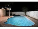 Sparkling in-ground pool with patio, a covered area and a privacy fence perfect for relaxation and outdoor entertaining at 1253 E Avila Ave, Casa Grande, AZ 85122
