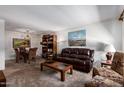 Spacious living room with a leather sofa, patterned chairs, and an adjacent dining area at 13642 N Silverbell Dr, Sun City, AZ 85351